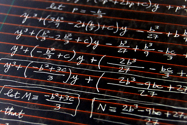 A chalkboard with math equations.