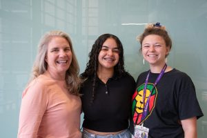 Gabriela P. Romero-González, a summer research program student, poses with her mentor, Ania Bialic and PI, Laura Knoll. All three of them are smiling at the camera. 