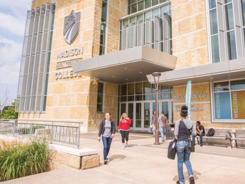 The entrance of the Madison College Truax Gateway building, with several students walking in front of it.