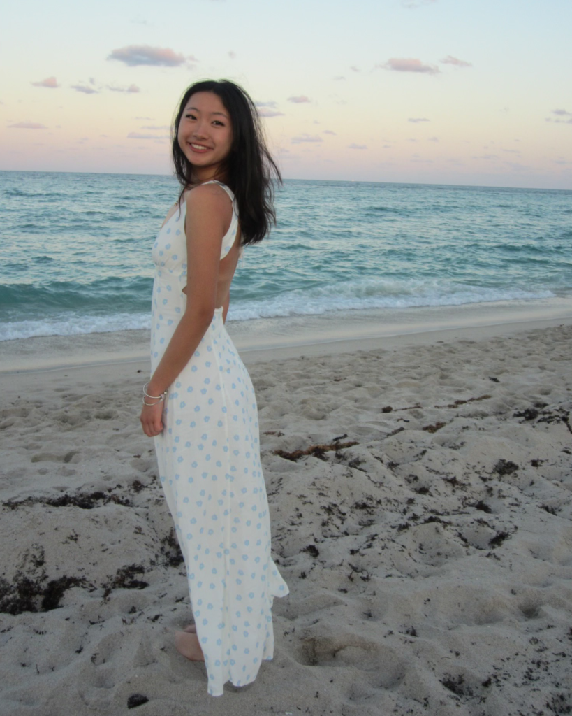 Amy Yi standing on a beach.