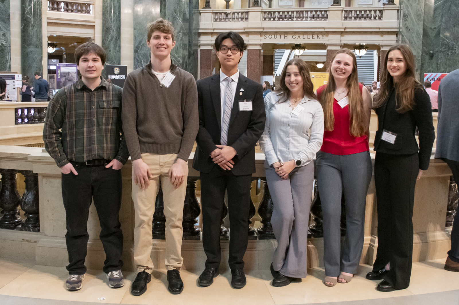 Six student researchers stand together in the rotunda of the Wisconsin State Capitol.
